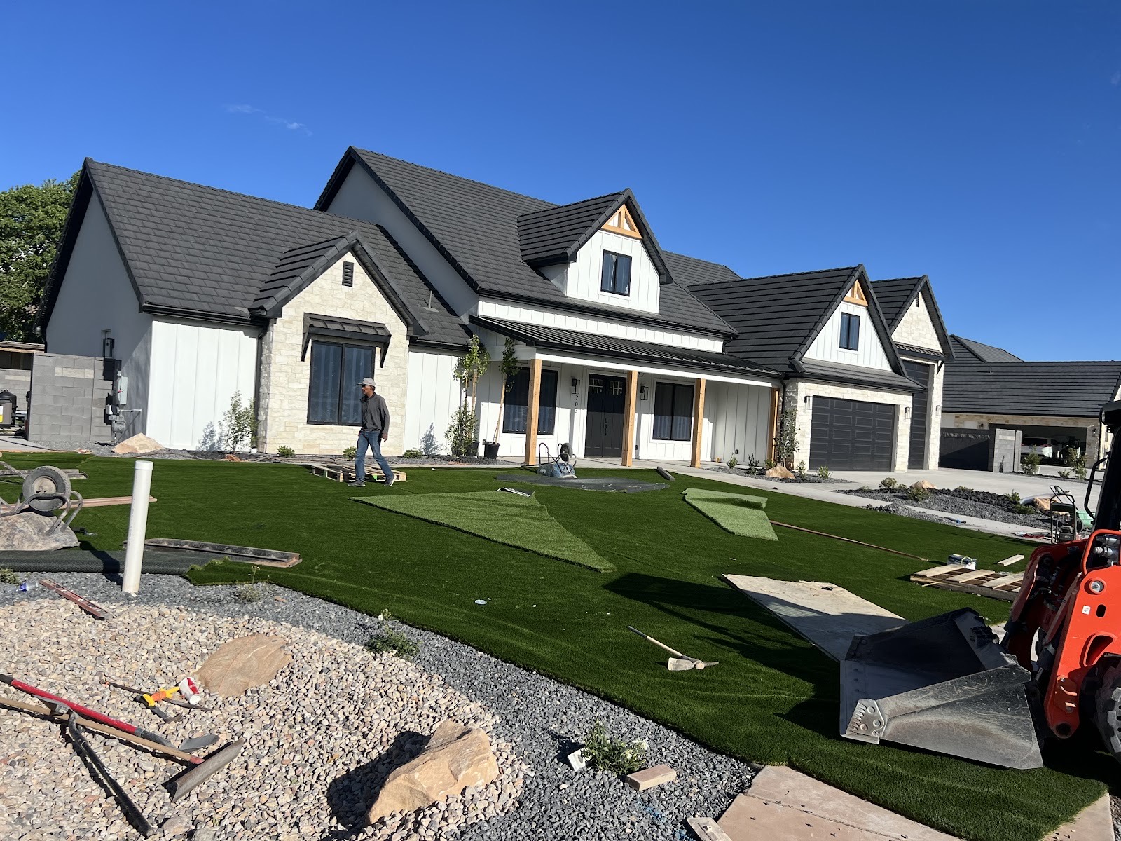 Freshly installed turf lawn at a luxury St. George home framed by red-rock desert, landscaped by Elite